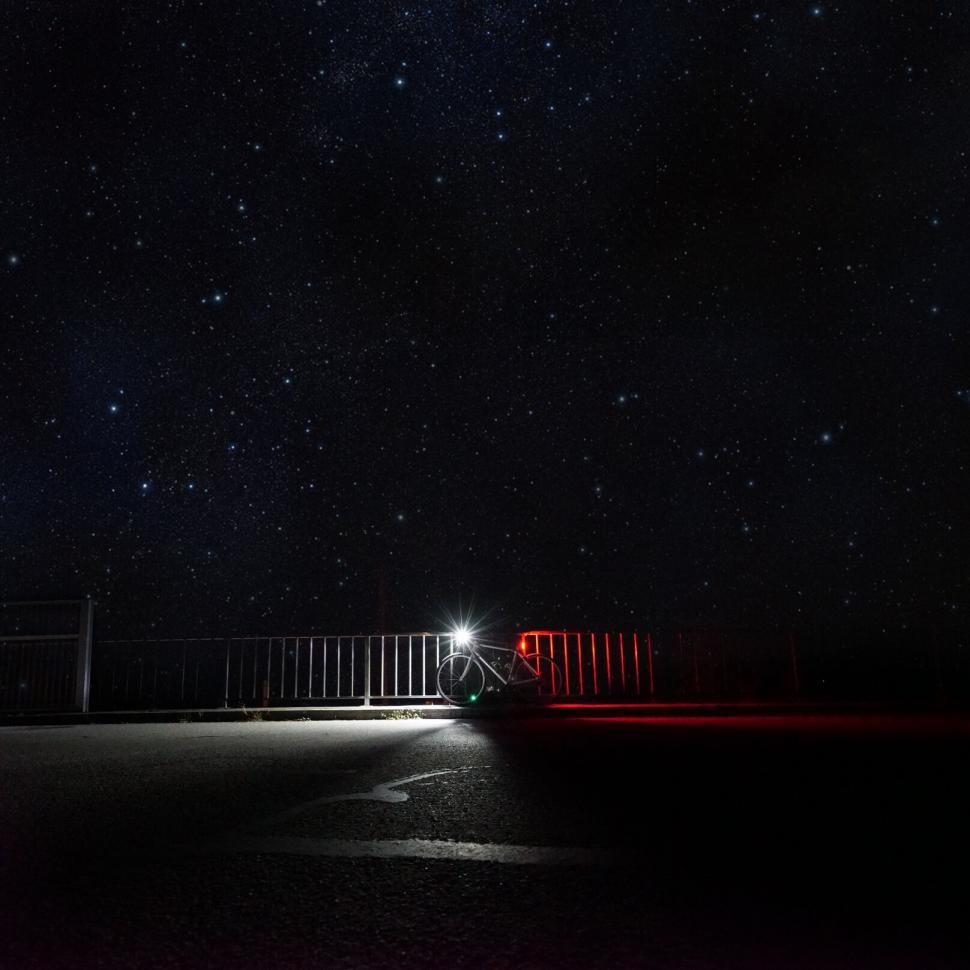 Free Image of Bicycle under starlit sky on a dark road 