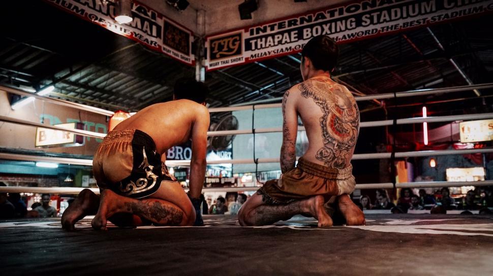 Free Image of Muay Thai fighters kneeling in a ring 