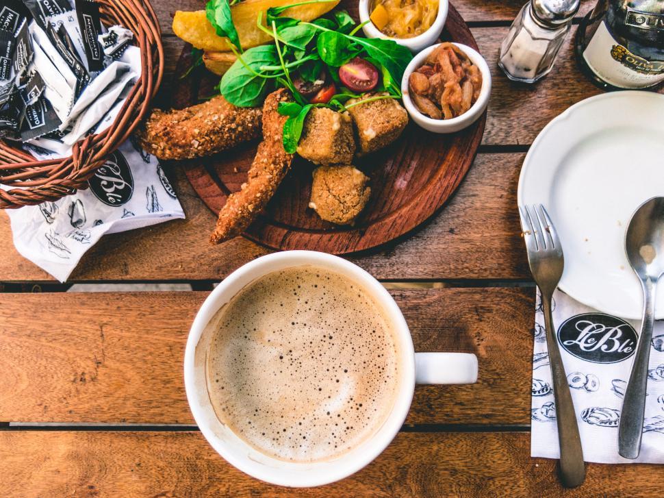 Free Image of Coffee and a Spread of Appetizing Snacks on a Table 