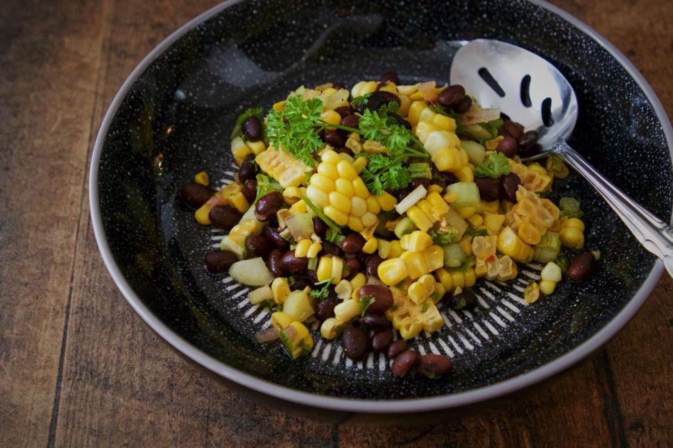 Free Image of Black bowl with beans corn and parsley 