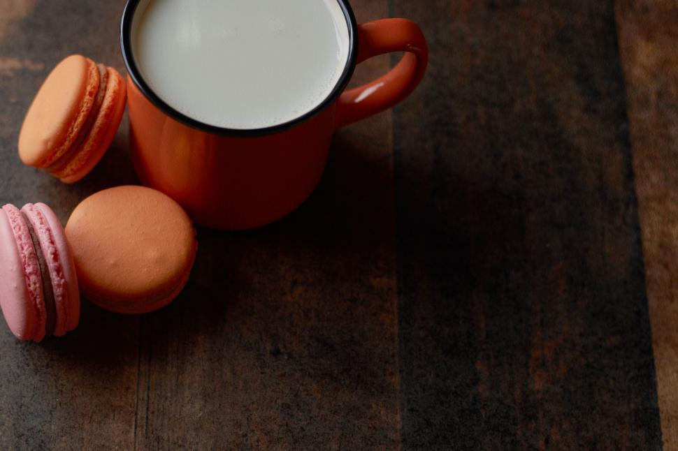 Free Image of Mug of milk and macarons on rustic background 