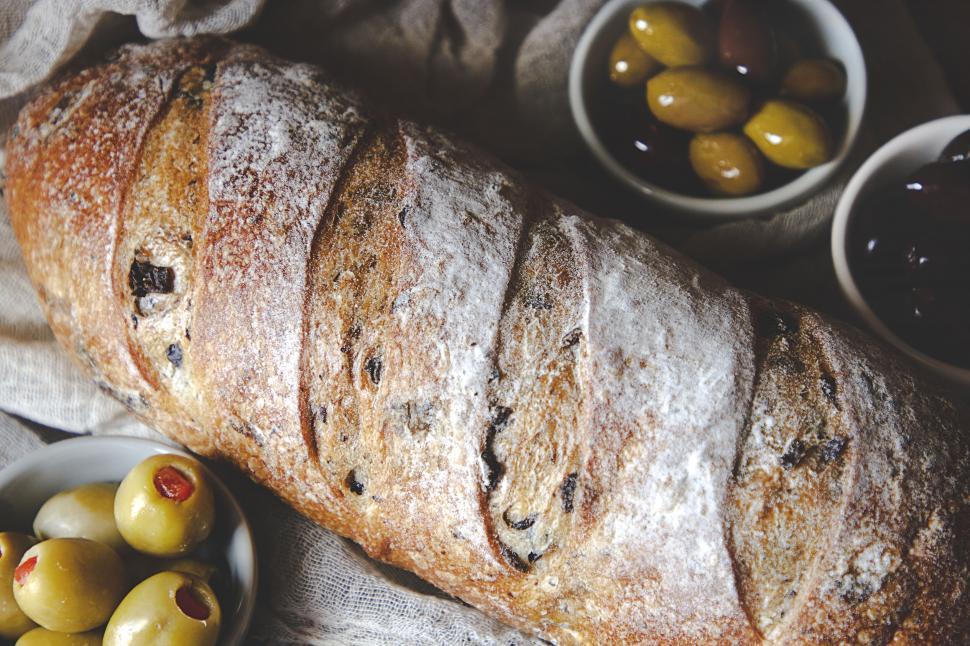 Free Image of Artisan olive bread on a rustic setup 