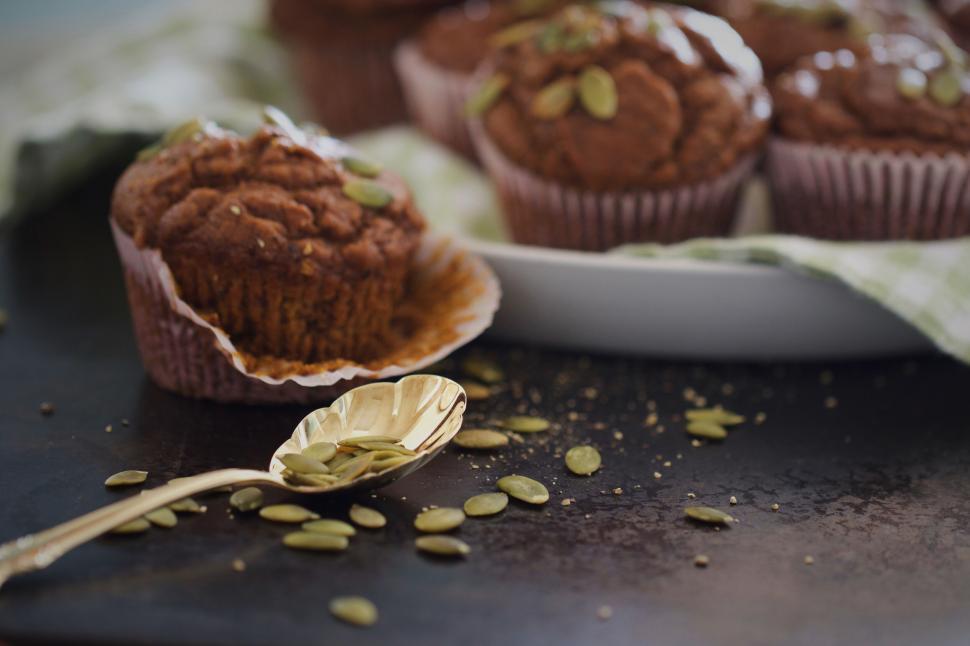 Free Image of Pumpkin muffins on a dark backdrop 