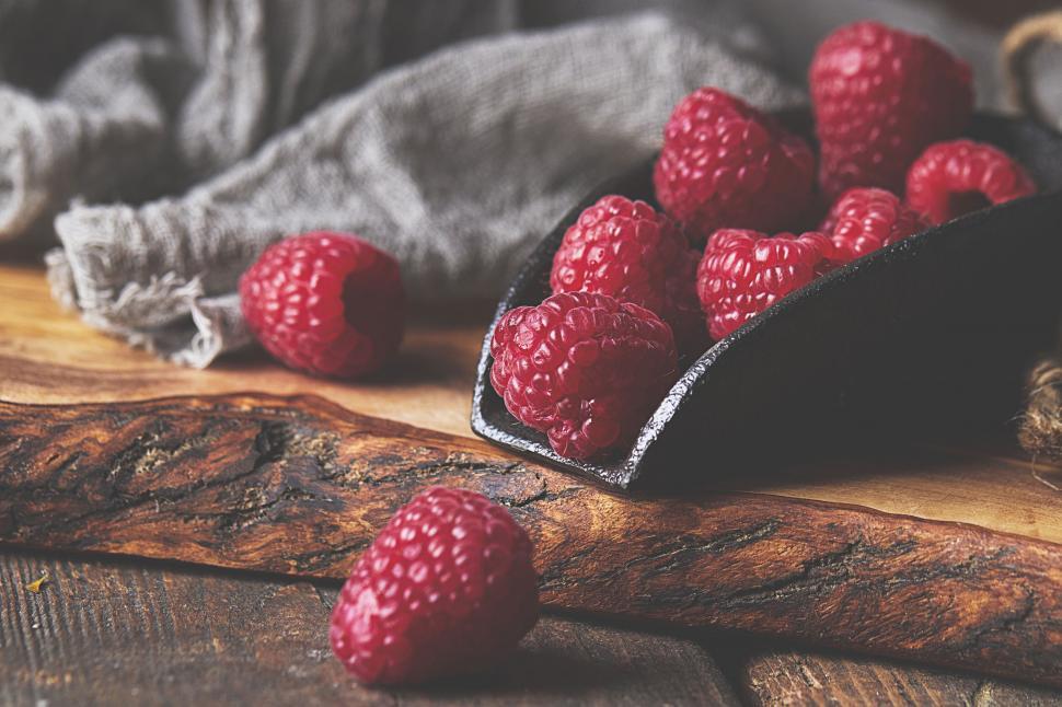 Free Image of Rustic raspberries on wooden surface 