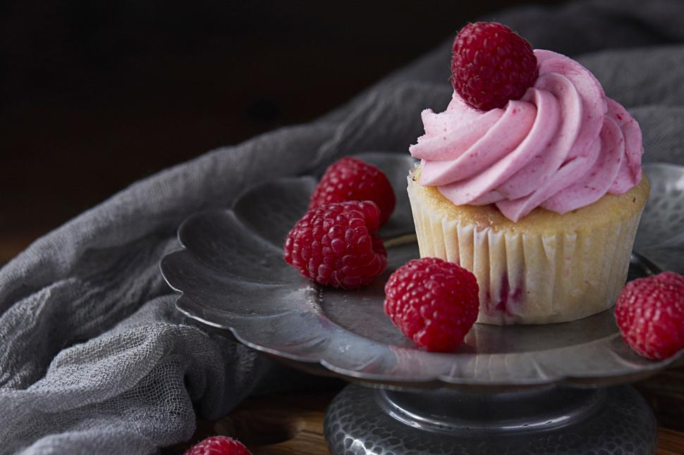 Free Image of Delicate cupcake with raspberry topping 