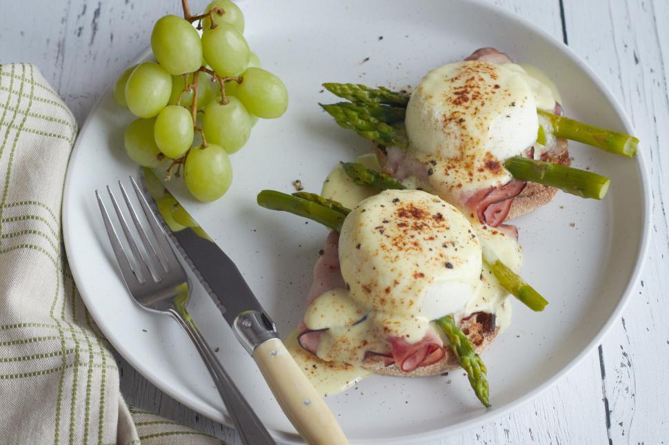 Free Image of Eggs Benedict elegantly plated with grapes 