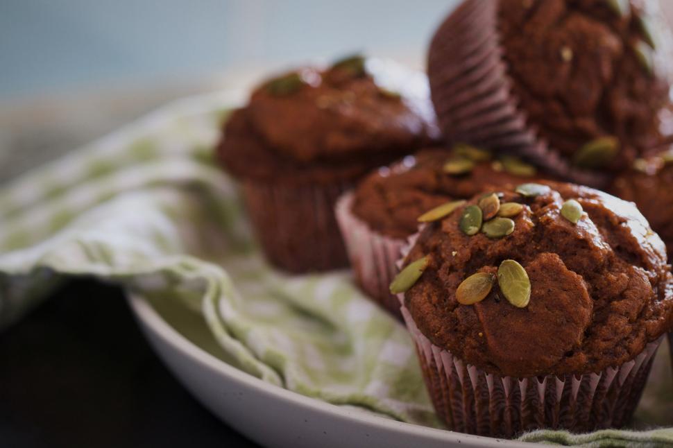 Free Image of Pumpkin seed topped muffins on plate 