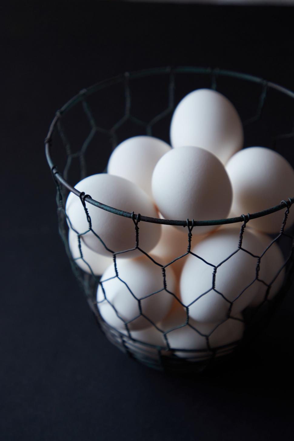 Free Image of White eggs in a wire basket 