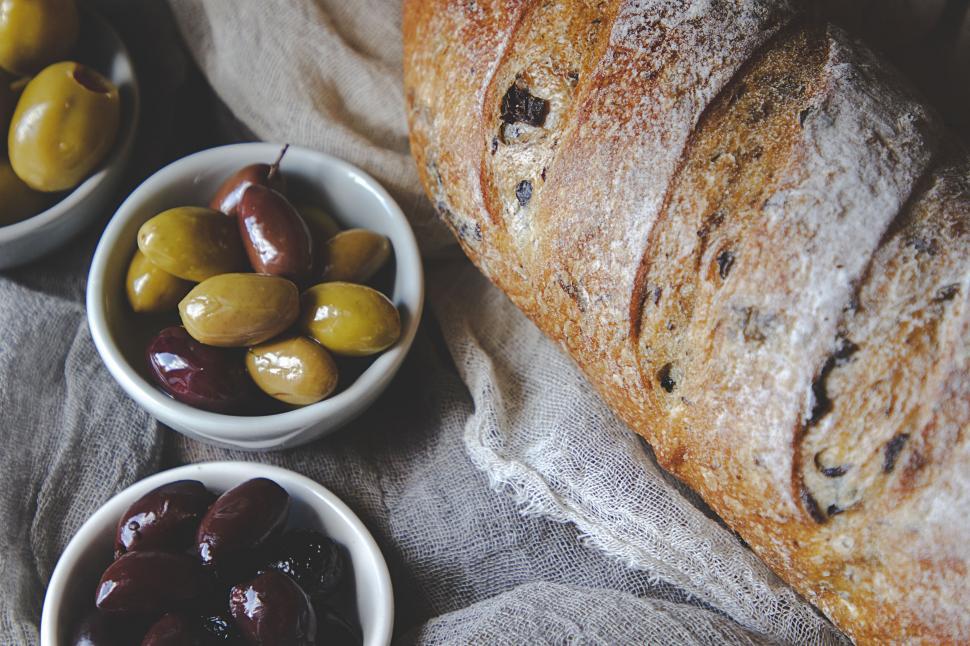 Free Image of Artisan olive bread with olives on rustic linen 