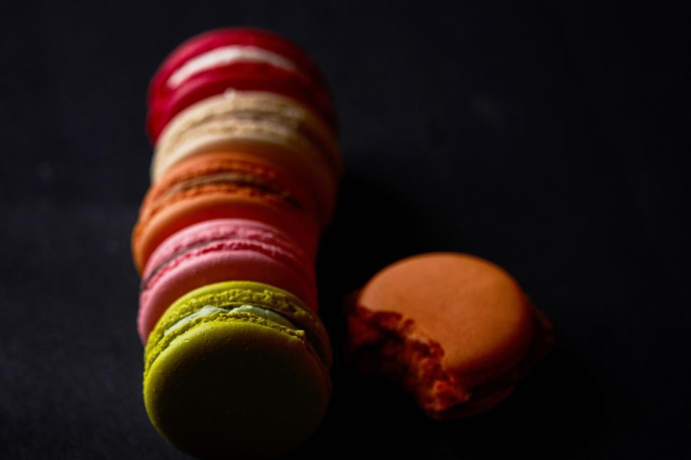 Free Image of Colorful macarons in a dark setting 