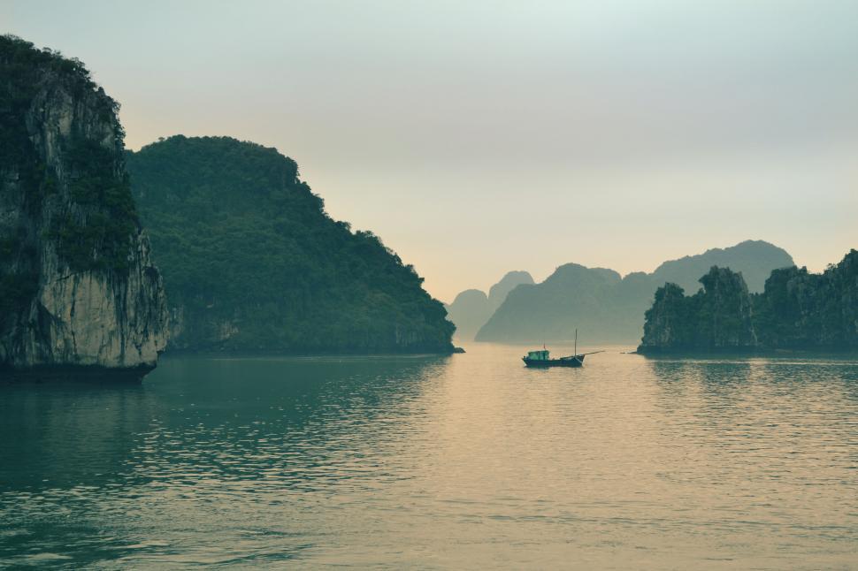 Free Image of Serene sunset over tranquil Halong Bay 