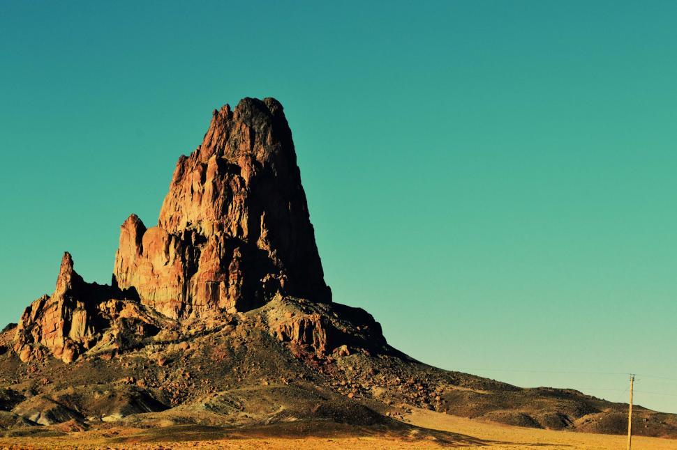 Free Image of Majestic rock formation under clear blue sky 