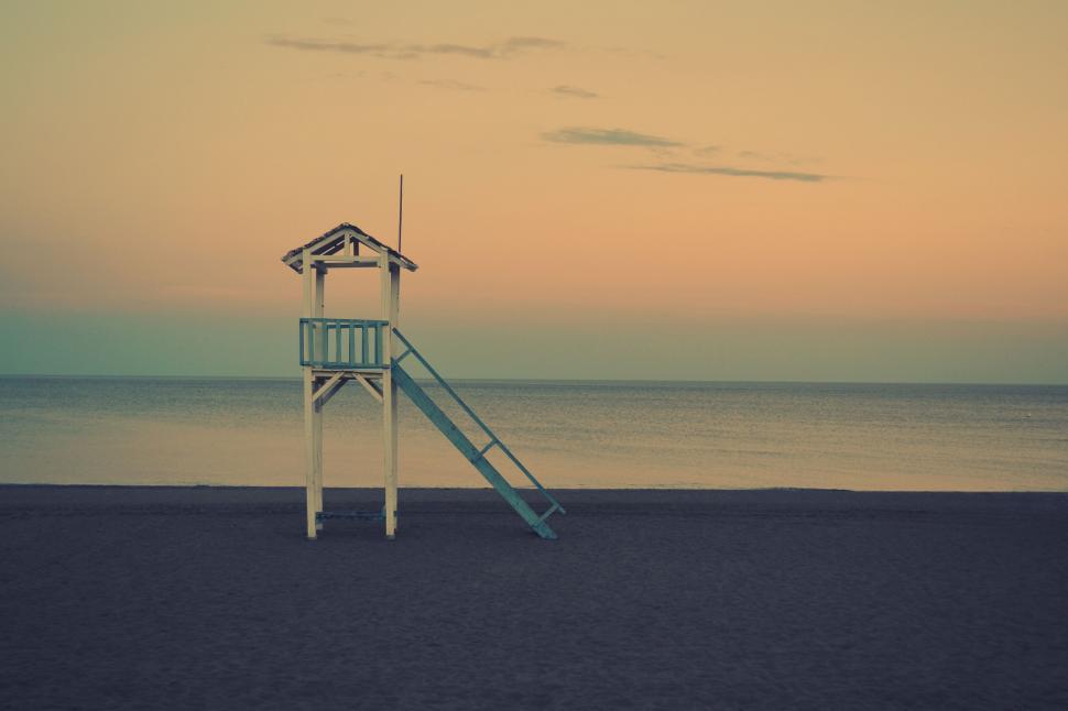 Free Image of Deserted beach with empty lifeguard stand 