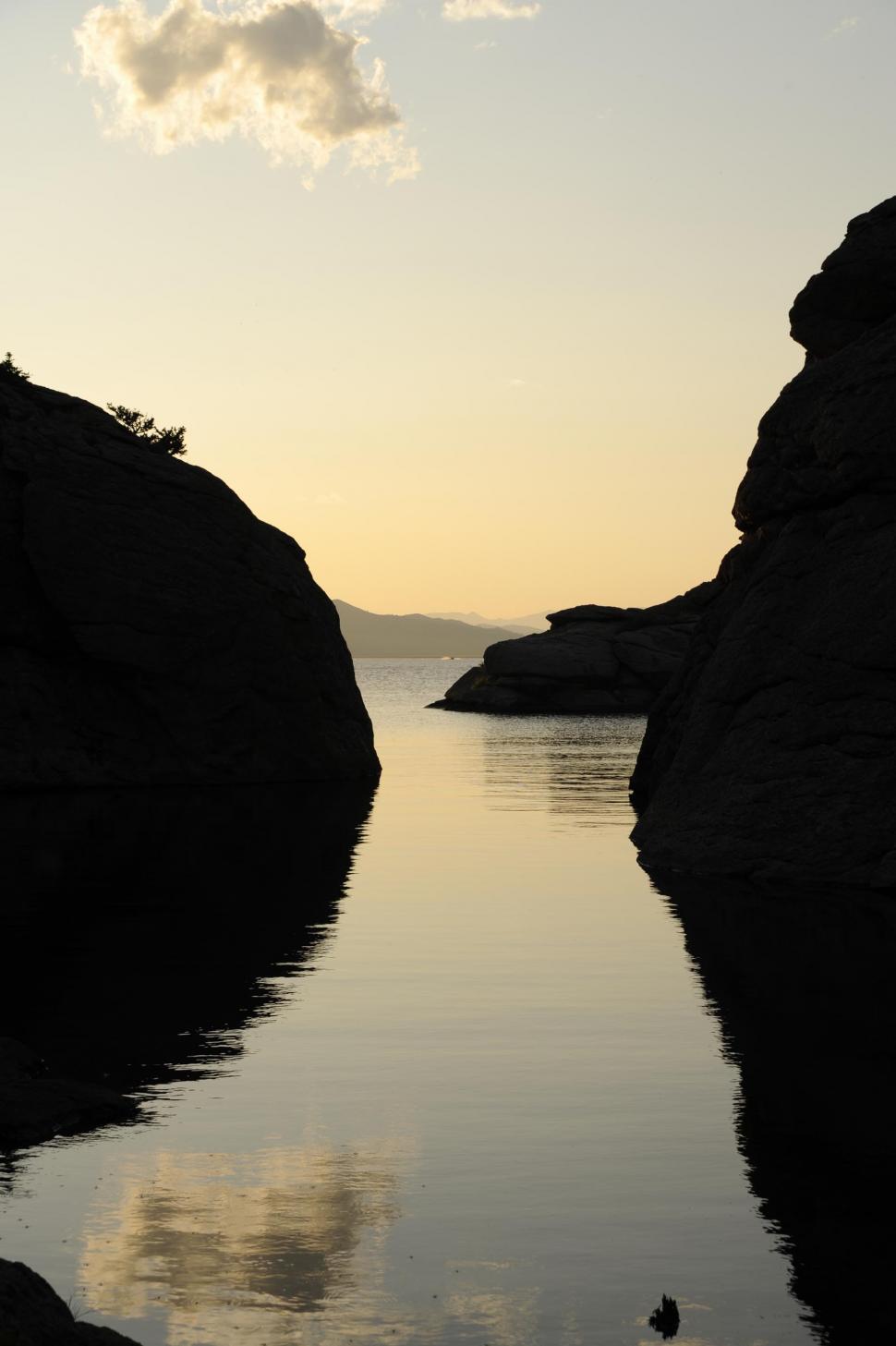 Free Image of View of rock and lake during sunset  