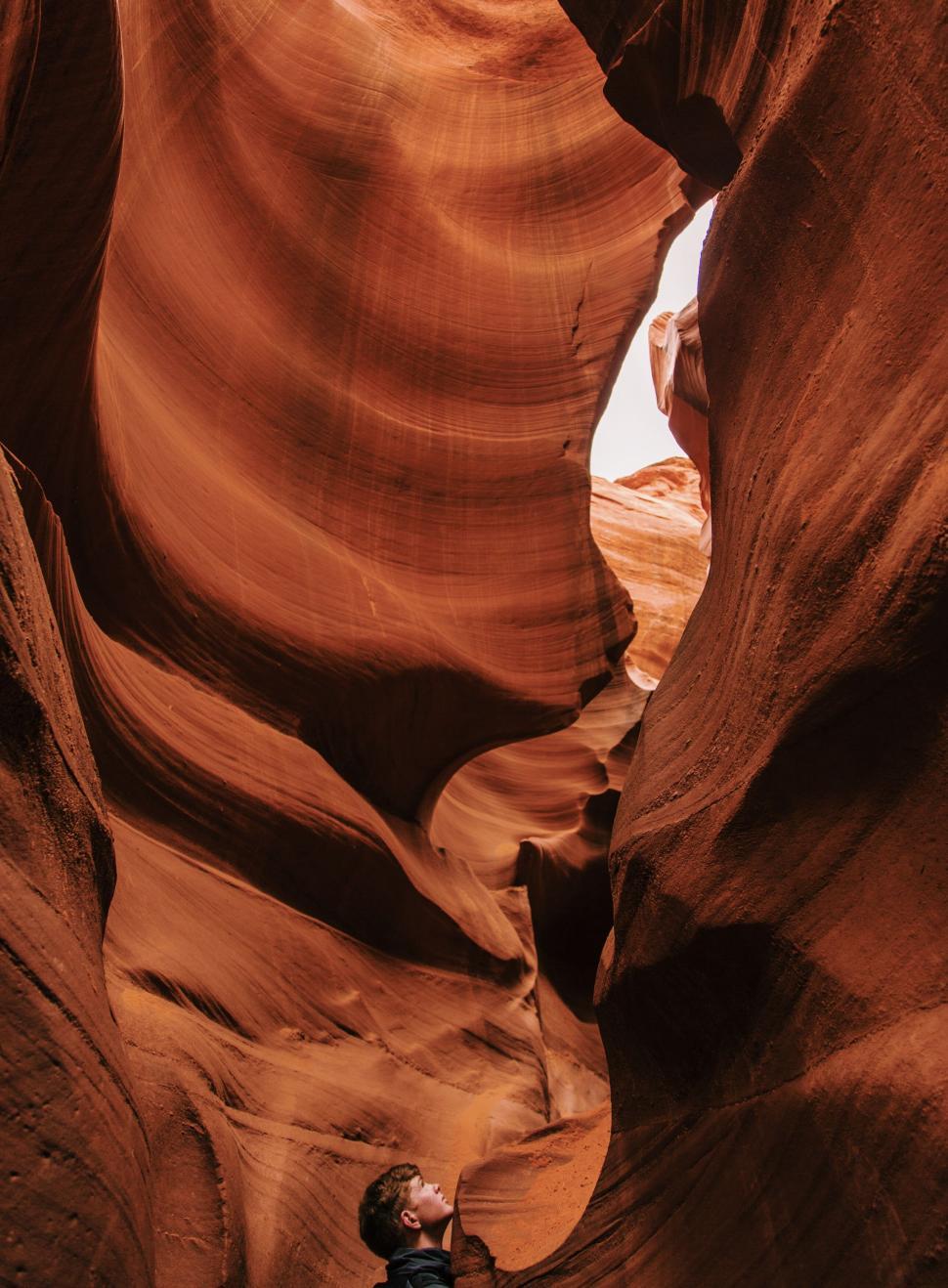 Free Image of Canyon explorer in narrow desert crevice 
