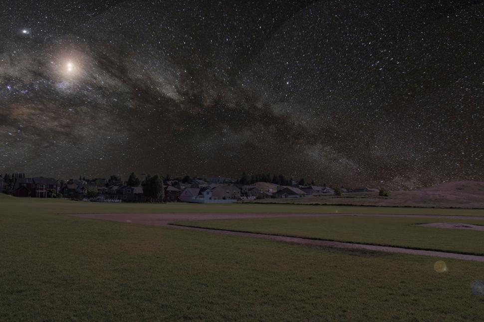 Free Image of Starry night sky over suburban neighborhood 
