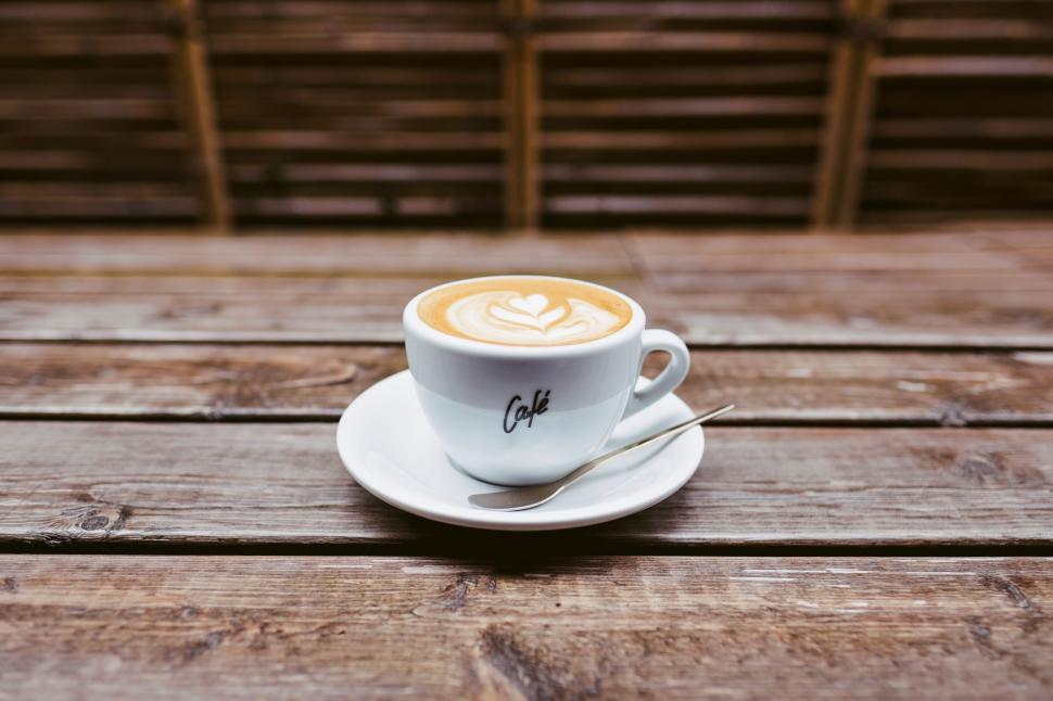 Free Image of Cup of latte on wooden table 