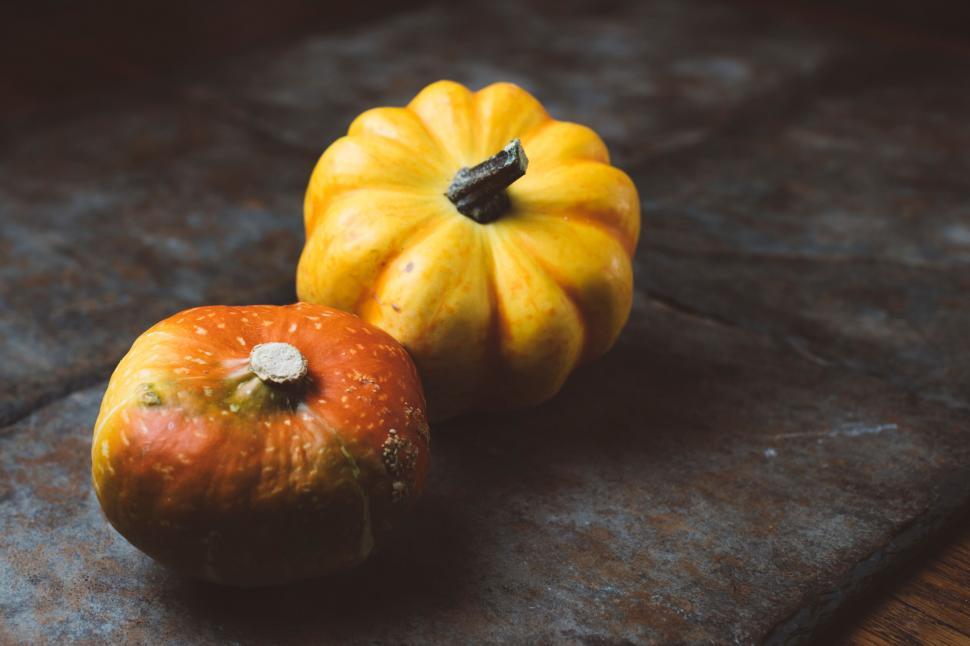 Free Image of Two pumpkins on a rustic wooden table 