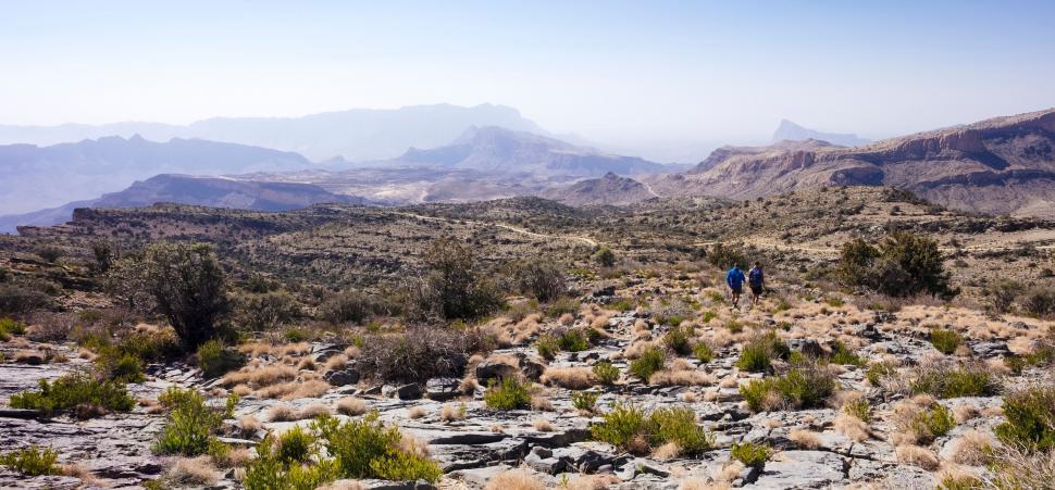 Free Image of Hikers exploring vast mountainous desert terrain 