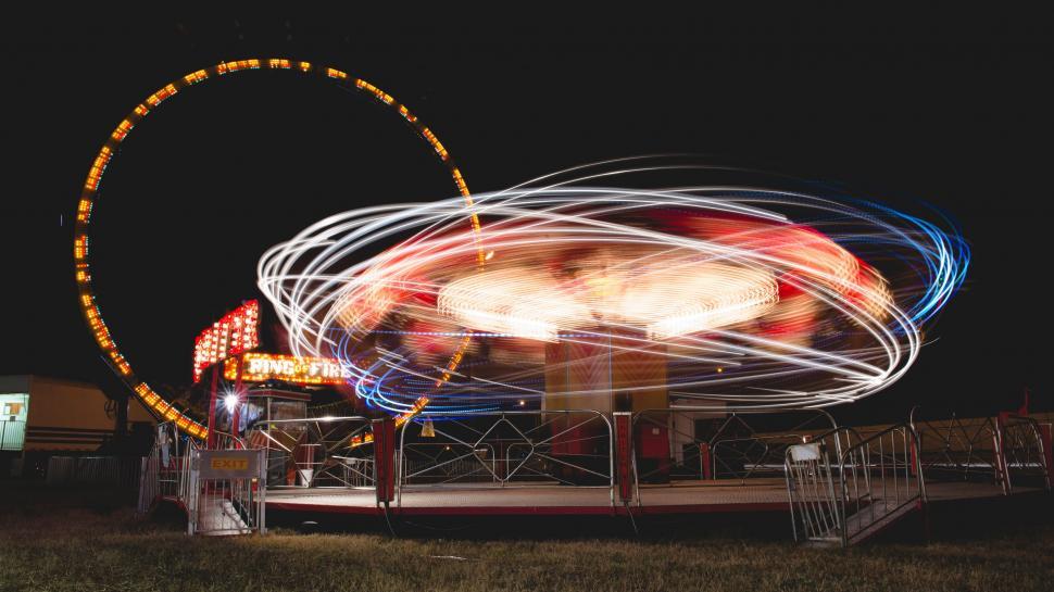 Free Image of Long exposure of a spinning fairground ride 