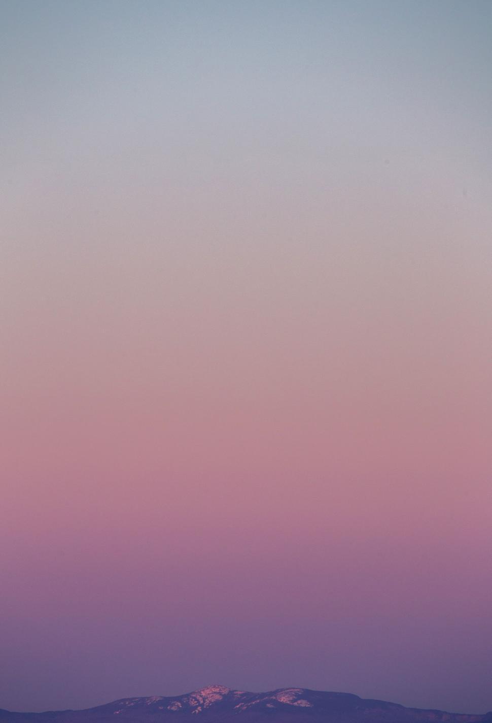 Free Image of Gradient sky over mountain silhouette 