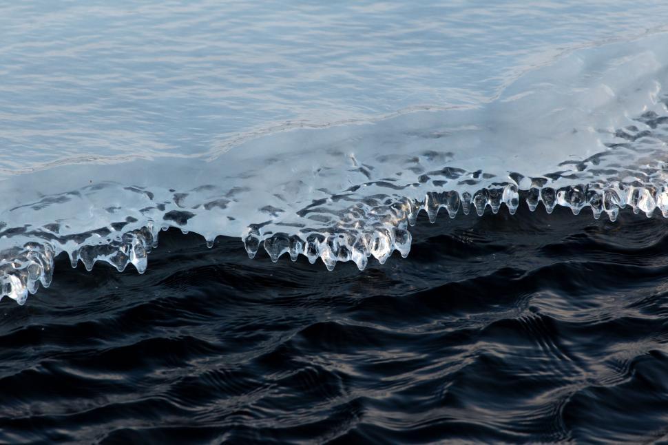 Free Image of Icy edge on a dark rippling lake 