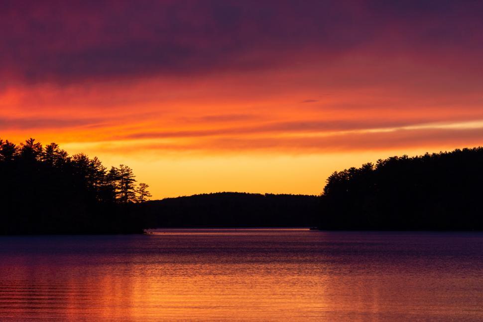 Free Image of Lakeside sunset with vibrant orange and red hues 