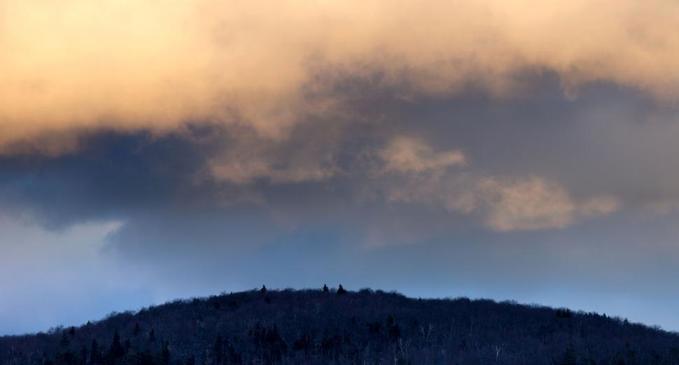 Free Image of Mountainous landscape shrouded in clouds at dusk 
