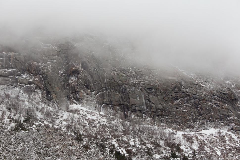 Free Image of Misty rocky mountain slope with snow 