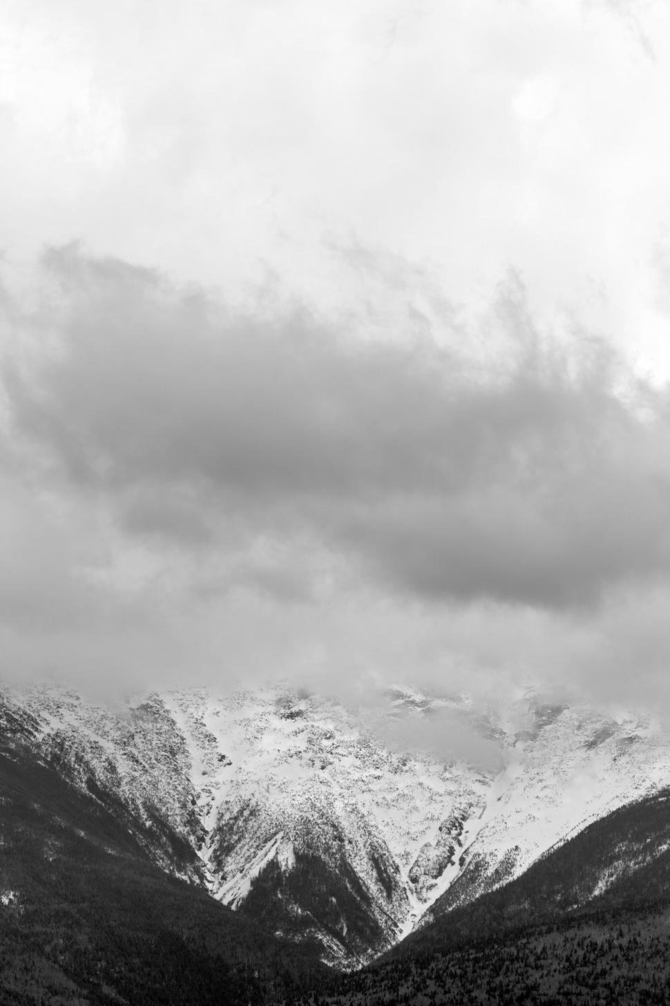 Free Image of Snow-capped mountain range under clouds 