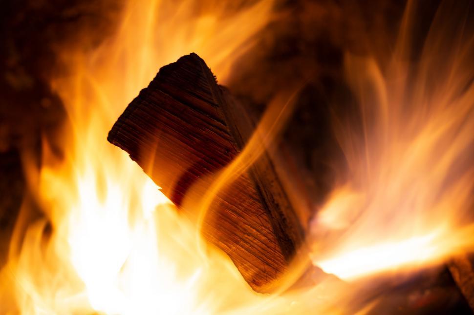 Free Image of Flames engulfing a log in a campfire 