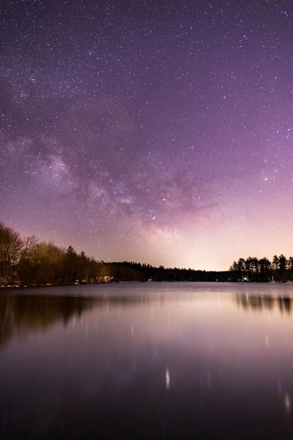 Free Image of Starry night sky over tranquil lake 