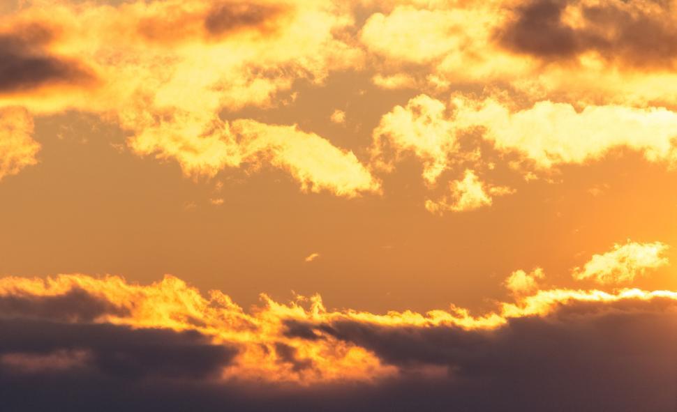 Free Image of Glowing golden clouds during sunset 