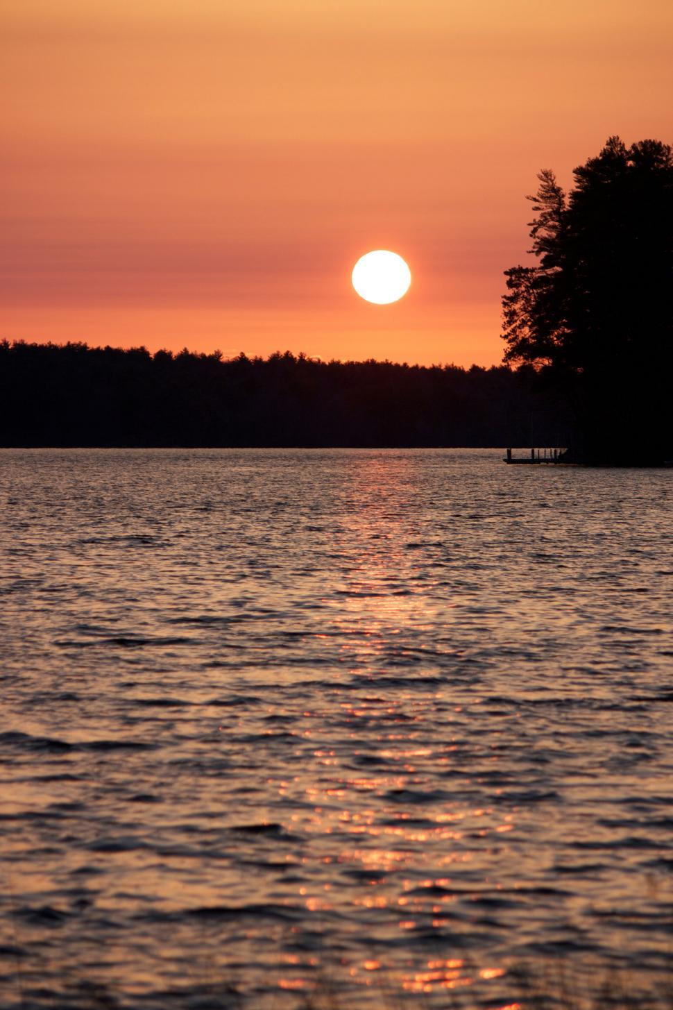Free Image of Sunset at the Lake with Forest Silhouette 