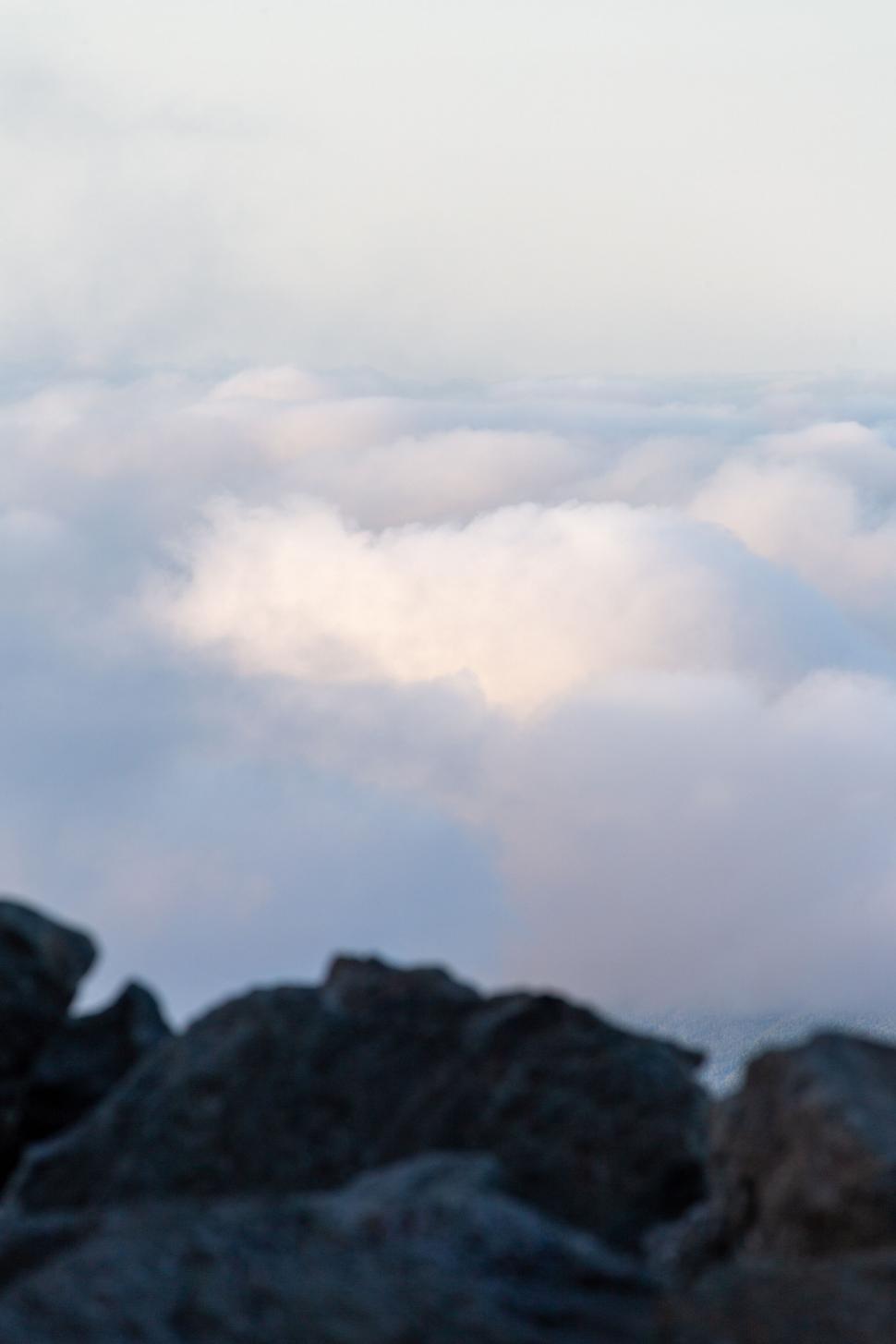 Free Image of Mysterious cloudscape over rocky terrain 