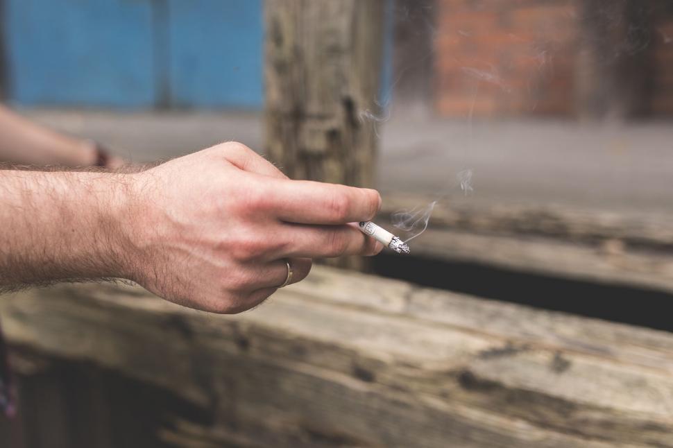 Free Image of Man smoking a cigarette outdoors 