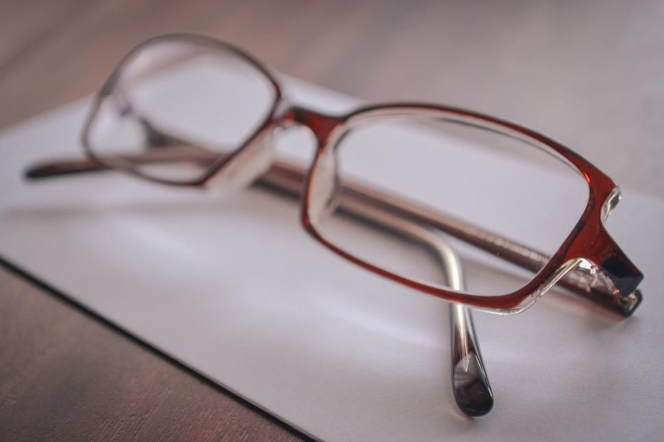 Free Image of Eyeglasses on a white notebook 