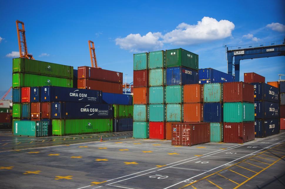 Free Image of Shipping containers stacked at a cargo terminal 