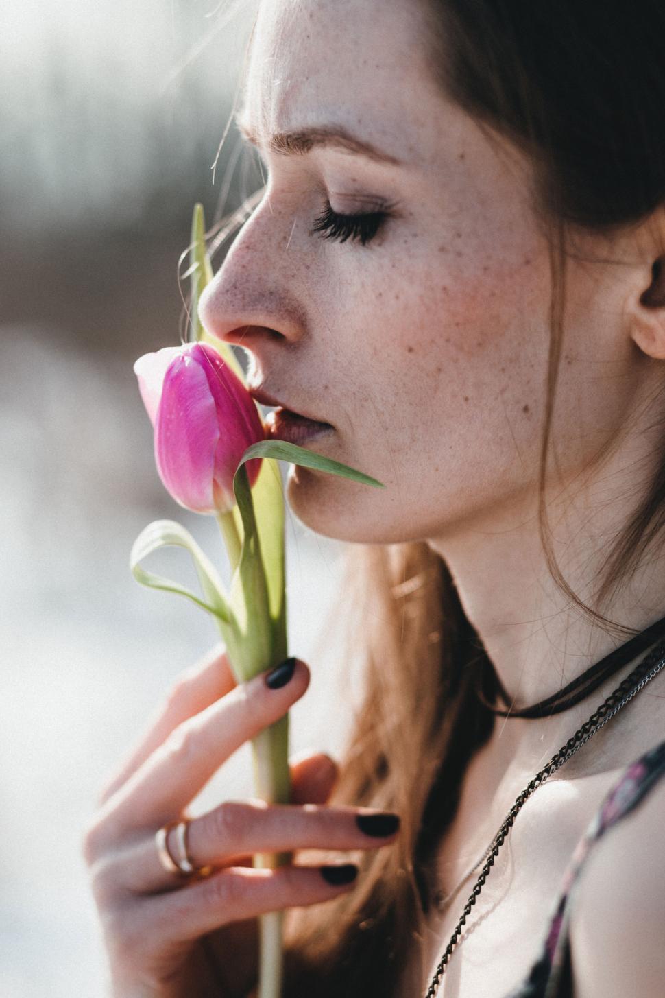 Free Image of Woman holding tulip flower in spring 