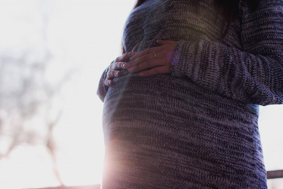 Free Image of Pregnant woman holding her belly 