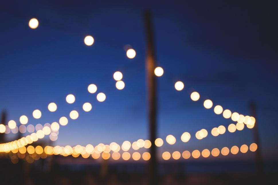 Free Image of Blurry string lights at dusk 