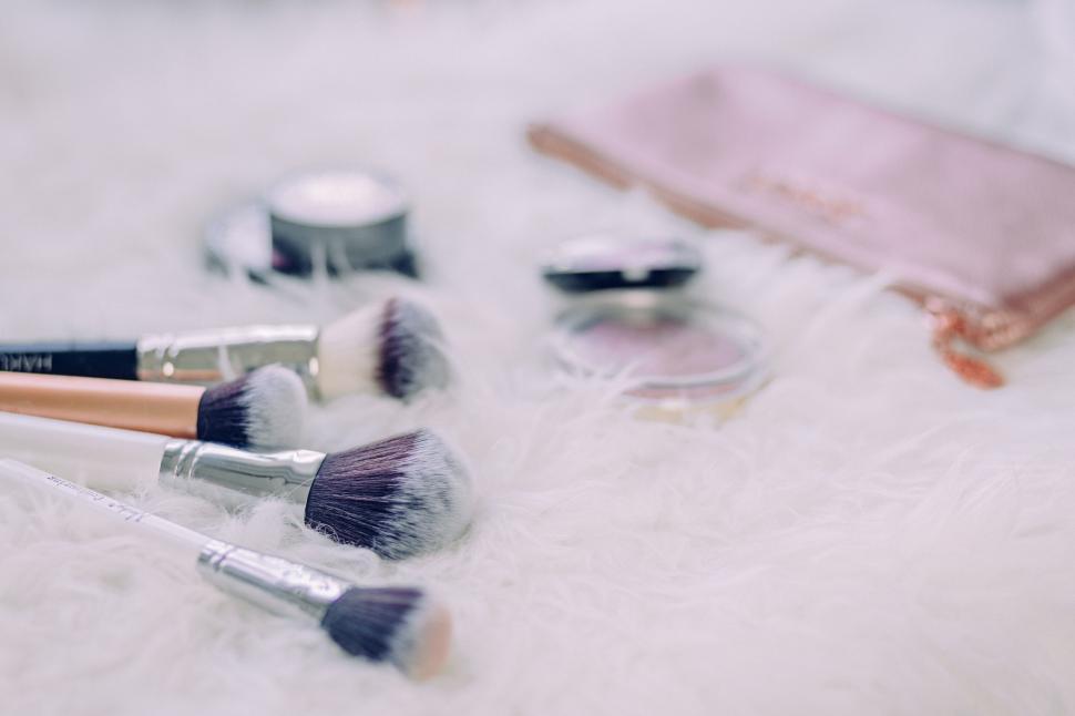 Free Image of Makeup brushes on white furry texture 