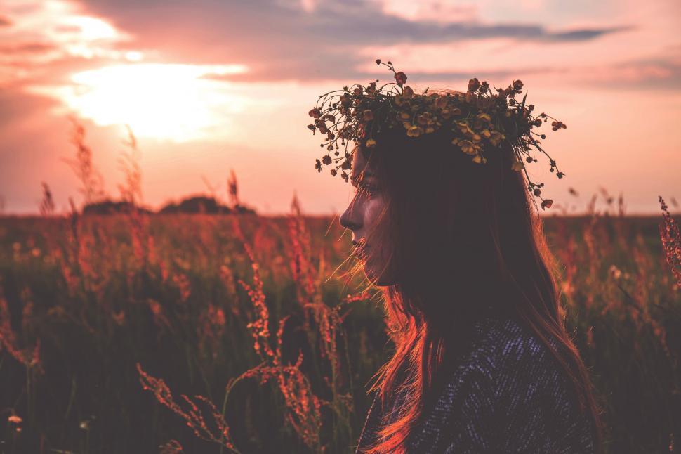 Free Image of Woman with flowers in hair at sunset 