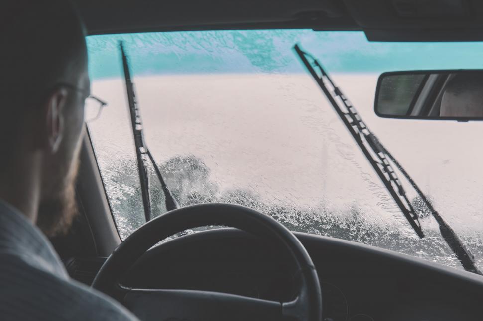 Free Image of Driver s view through a rain-soaked windshield 