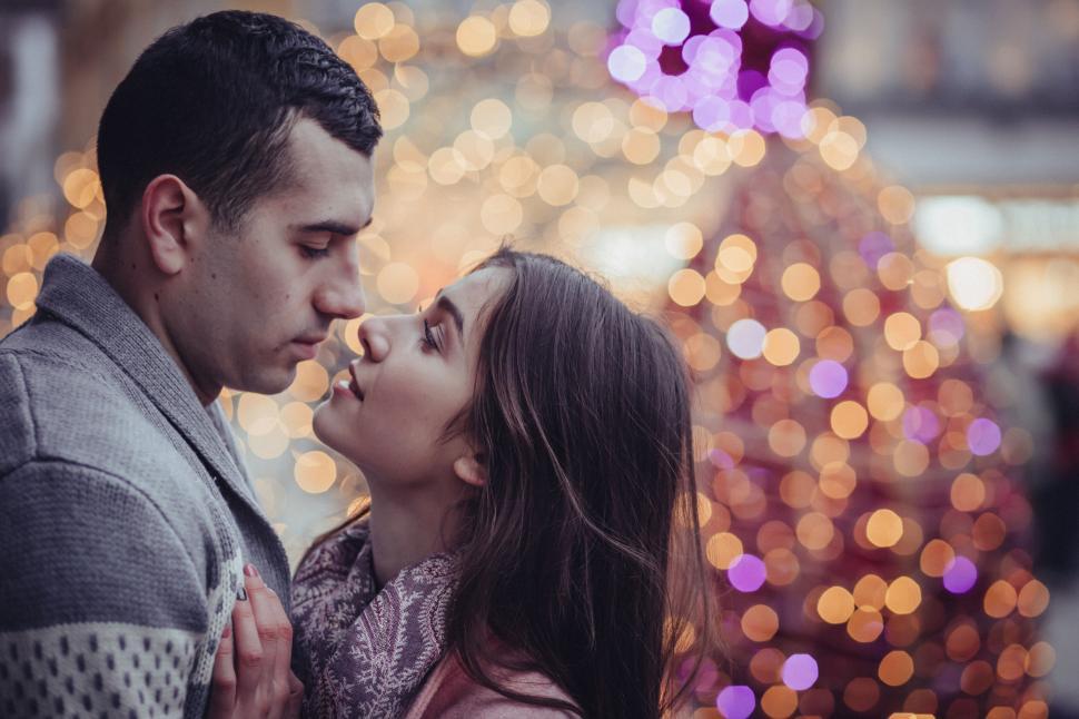 Free Image of Couple close up with blurred faces against lights 