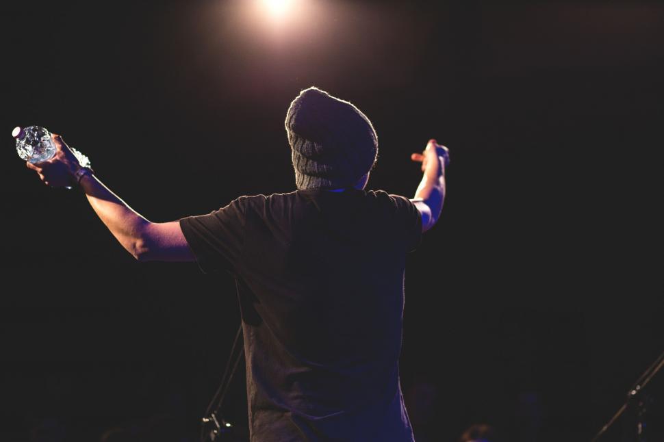 Free Image of Performer holding microphone on stage 