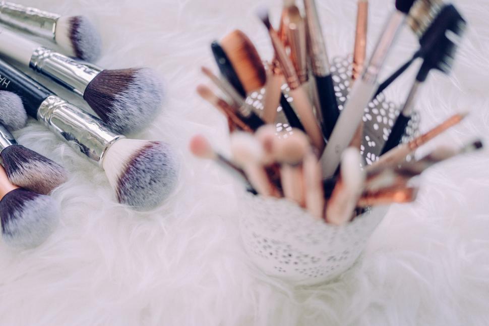 Free Image of Makeup brushes collection on fluffy surface 