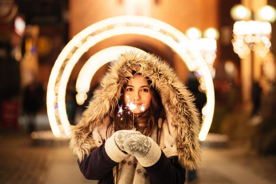 Free Image of Woman holding sparkler with illuminated rings 