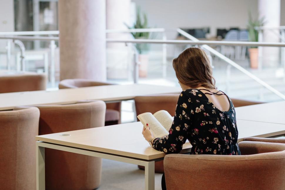 Free Image of Woman studying at a modern library table 