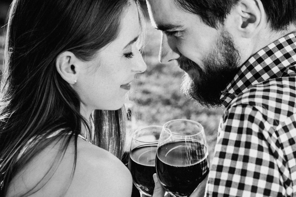 Free Image of Couple Enjoying Red Wine Outdoors 